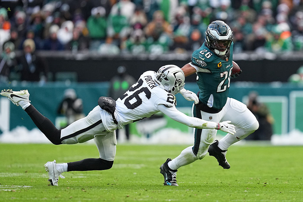 PHILADELPHIA, PENNSYLVANIA - DECEMBER 14: Saquon Barkley #26 of the Philadelphia Eagles carries the...