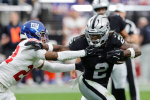 LAS VEGAS, NEVADA - DECEMBER 28: Ashton Jeanty #2 of the Las Vegas Raiders rushes for yards during the second quarter of the game against Andru Phillips #22 of the New York Giants at Allegiant Stadium on December 28, 2025 in Las Vegas, Nevada. (Photo by Steve Marcus/Getty Images)