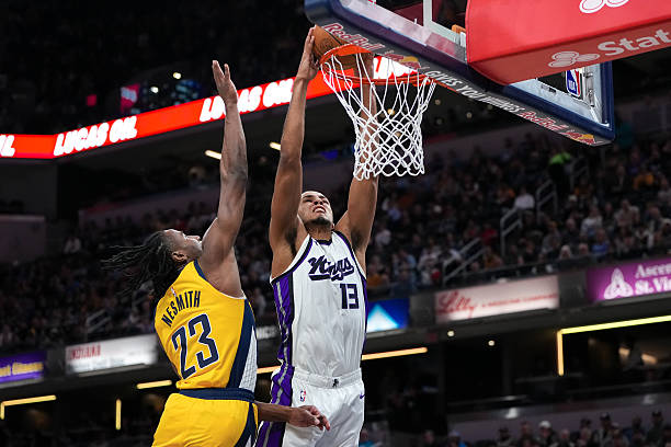 INDIANAPOLIS, INDIANA - MARCH 31: Keegan Murray #13 of the Sacramento Kings dunks the ball past Aar...