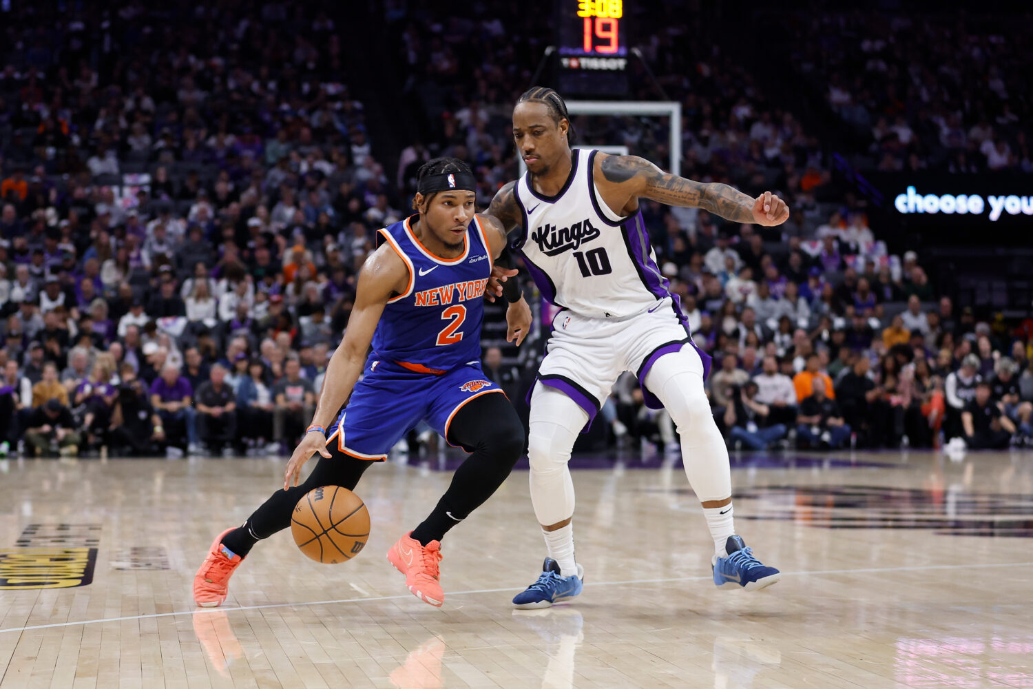 SACRAMENTO, CALIFORNIA - MARCH 10: Miles McBride #2 of the New York Knicks dribbles the ball to the...