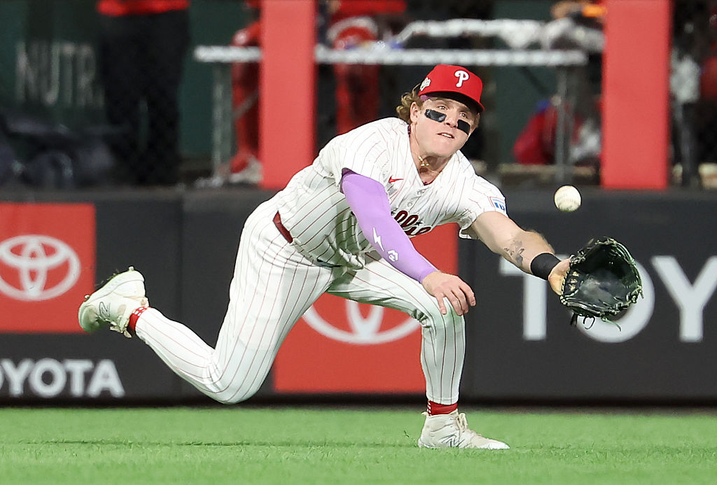 PHILADELPHIA, PENNSYLVANIA - OCTOBER 04: Harrison Bader #2 of the Philadelphia Phillies dives to ma...