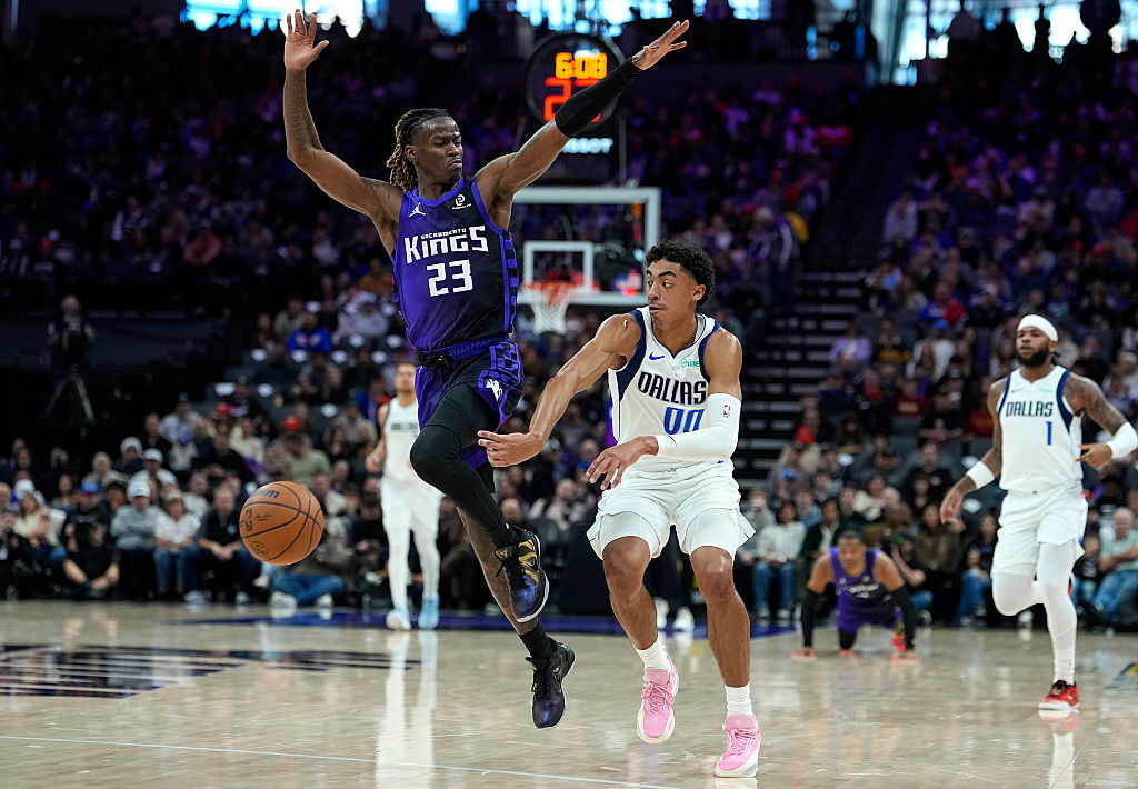 SACRAMENTO, CALIFORNIA - DECEMBER 27: Max Christie #00 of the Dallas Mavericks passes the ball by t...