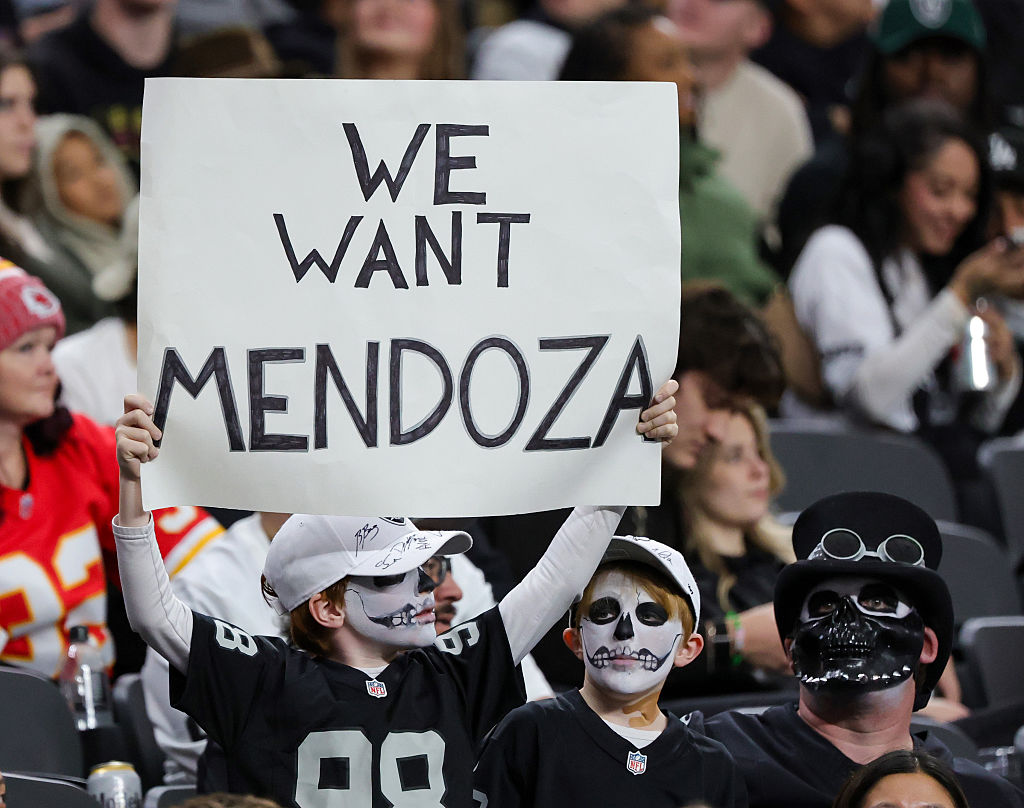 LAS VEGAS, NEVADA - JANUARY 04: Las Vegas Raiders fan Ezra Kheel (L) of Nevada holds up a sign refe...