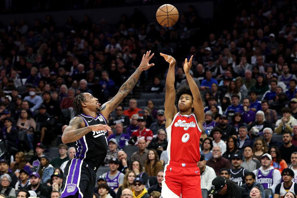 SACRAMENTO, CALIFORNIA - JANUARY 03: Jaylen Wells #0 of the Memphis Grizzlies shoots over DeMar DeR...