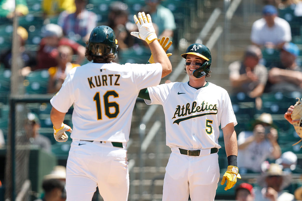 SACRAMENTO, CALIFORNIA - JULY 13: Nick Kurtz #16 of the Athletics celebrates with Jacob Wilson #5 a...