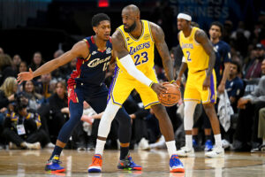 CLEVELAND, OHIO - JANUARY 28: LeBron James #23 of the Los Angeles Lakers runs a play while under pressure from De'Andre Hunter #12 of the Cleveland Cavaliers during the fourth quarter at Rocket Arena on January 28, 2026, in Cleveland, Ohio. The Cavaliers defeated the Lakers 129-99. NOTE TO USER: User expressly acknowledges and agrees that, by downloading and or using this photograph, User is consenting to the terms and conditions of the Getty Images License Agreement. (Photo by Jason Miller/Getty Images)