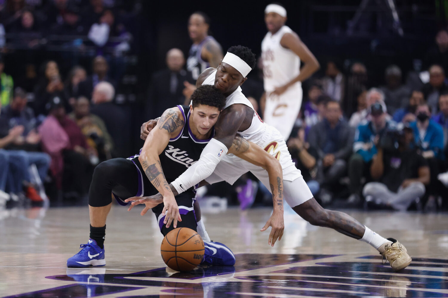 SACRAMENTO, CALIFORNIA - FEBRUARY 07: Nique Clifford #5 of the Sacramento Kings and Dennis Schroder...