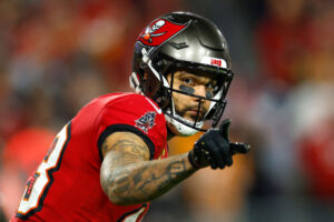 TAMPA, FLORIDA - JANUARY 12: Mike Evans #13 of the Tampa Bay Buccaneers points against the Washington Commanders during the fourth quarter in the NFC Wild Card Playoff at Raymond James Stadium on January 12, 2025 in Tampa, Florida. (Photo by Mike Ehrmann/Getty Images)