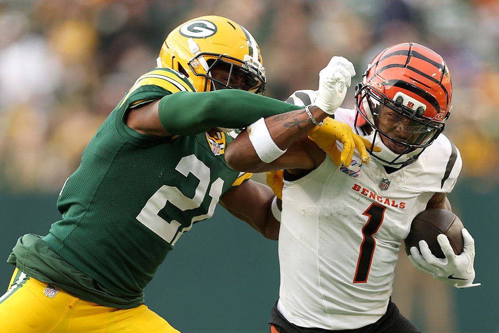 GREEN BAY, WISCONSIN - OCTOBER 12: Ja'Marr Chase #1 of the Cincinnati Bengals is pushed out of boun...