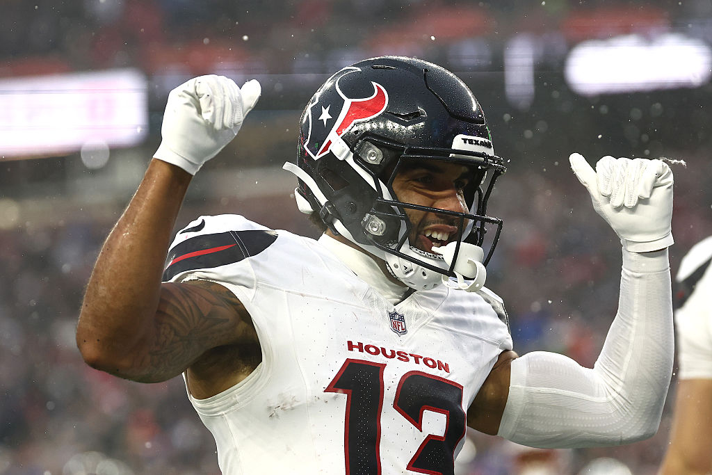 FOXBOROUGH, MASSACHUSETTS - JANUARY 18: Christian Kirk #13 of the Houston Texans celebrates after s...