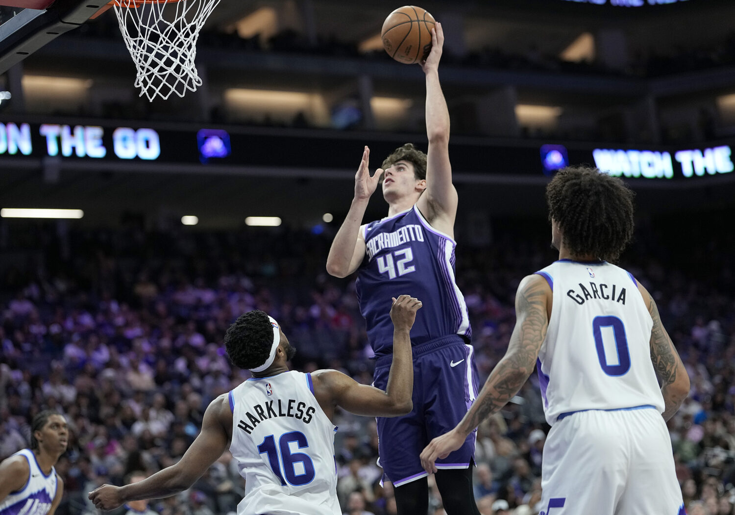 SACRAMENTO, CALIFORNIA - MARCH 15: Maxime Raynaud #42 of the Sacramento Kings shoots over Elijah Ha...