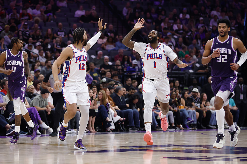SACRAMENTO, CALIFORNIA - MARCH 19: Andre Drummond #1 of the Philadelphia 76ers celebrates with Tren...
