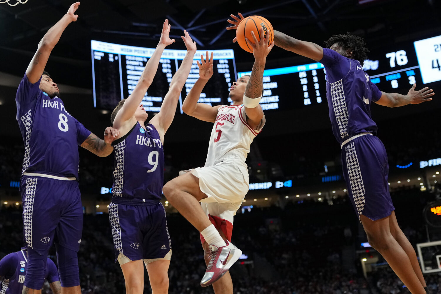 PORTLAND, OREGON - MARCH 21: Darius Acuff Jr. #5 of the Arkansas Razorbacks attempts a shot while b...