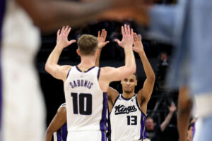SACRAMENTO, CALIFORNIA - APRIL 16: Keegan Murray #13 of the Sacramento Kings is congratulated by De'Aaron Fox #5 and Domantas Sabonis #10 of the Sacramento Kings during their game against the Golden State Warriors in the second half during the Play-In Tournament at Golden 1 Center on April 16, 2024 in Sacramento, California. NOTE TO USER: User expressly acknowledges and agrees that, by downloading and or using this photograph, User is consenting to the terms and conditions of the Getty Images License Agreement. (Photo by Ezra Shaw/Getty Images)