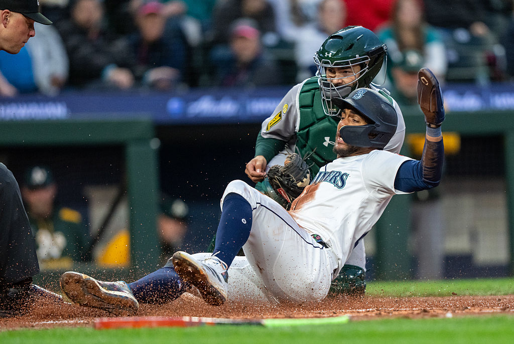 SEATTLE, WA -MARCH 29: Julio Rodriguez #44 of the Seattle Mariners is tagged out by catcher Shea La...