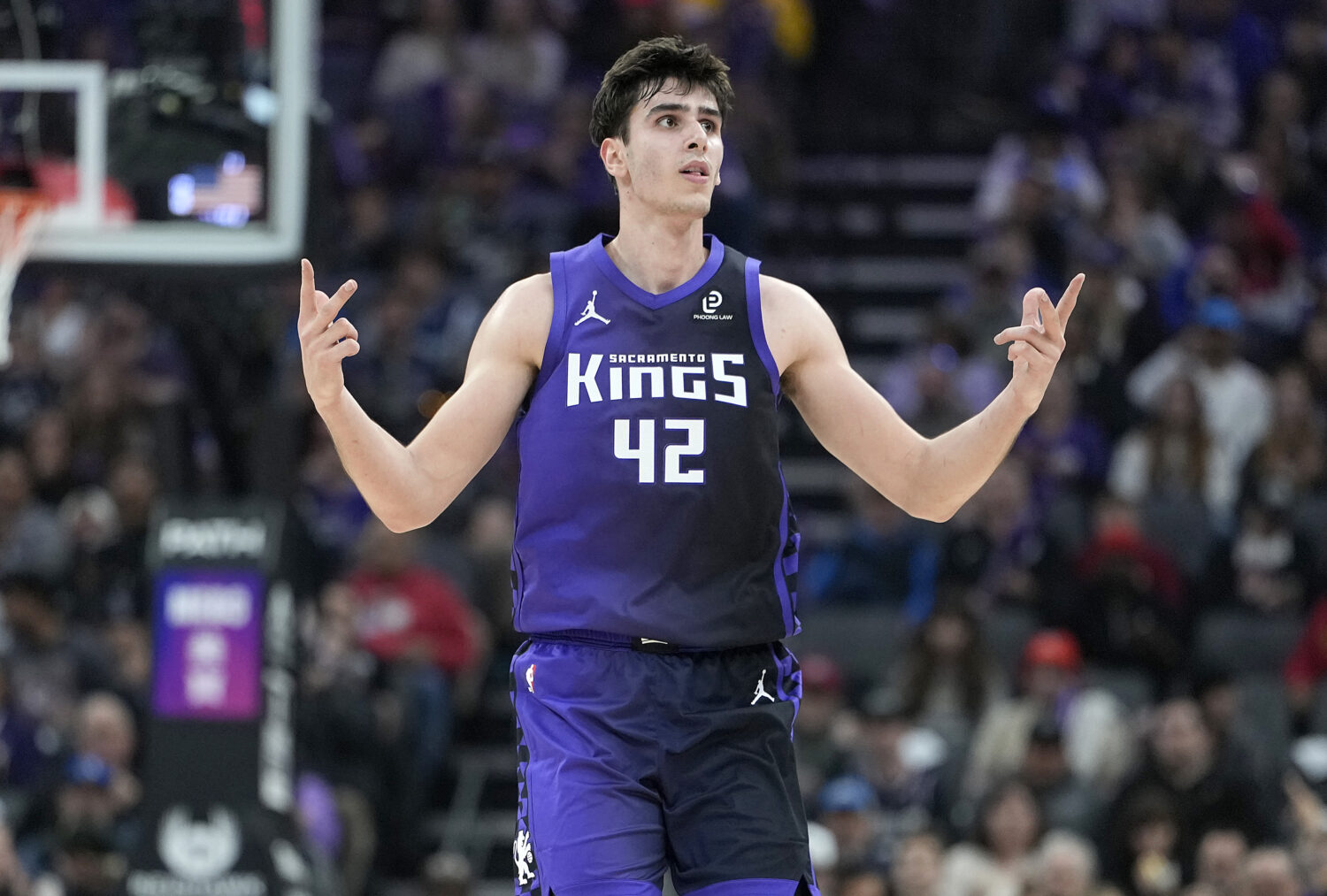 SACRAMENTO, CALIFORNIA - DECEMBER 27: Maxime Raynaud #42 of the Sacramento Kings reacts after makin...