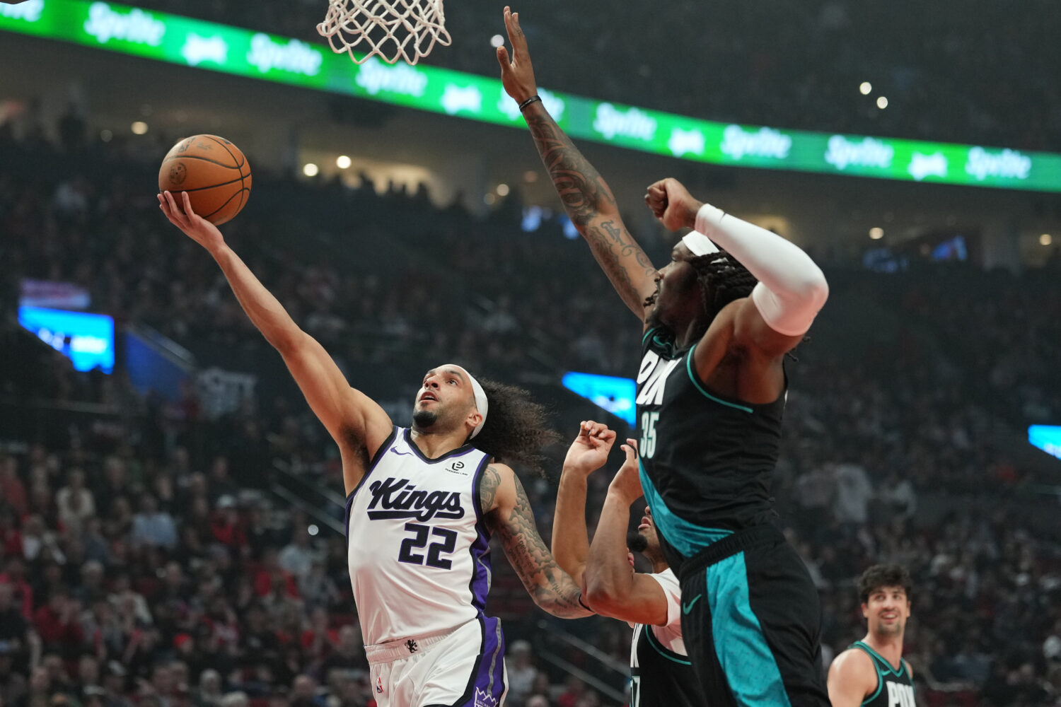 PORTLAND, OREGON - APRIL 12: Devin Carter #22 of the Sacramento Kings attempts a layup defended by ...
