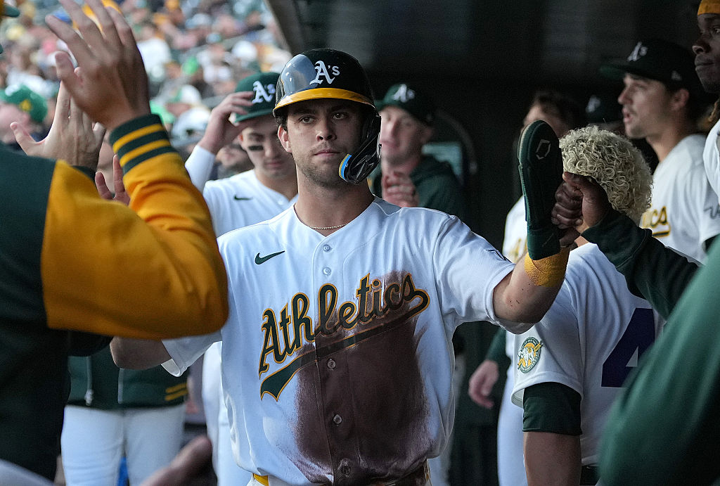 SACRAMENTO, CALIFORNIA - APRIL 15: Max Muncy #3 of the Athletics is congratulated by teammates in t...