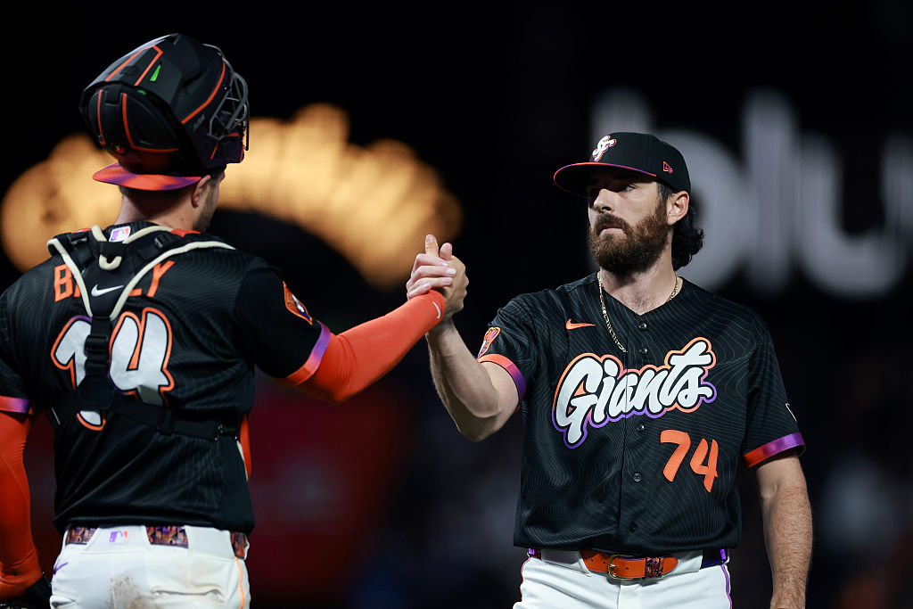 SAN FRANCISCO, CALIFORNIA - APRIL 21: Ryan Walker #74 shakes hands with Patrick Bailey #14 of the S...