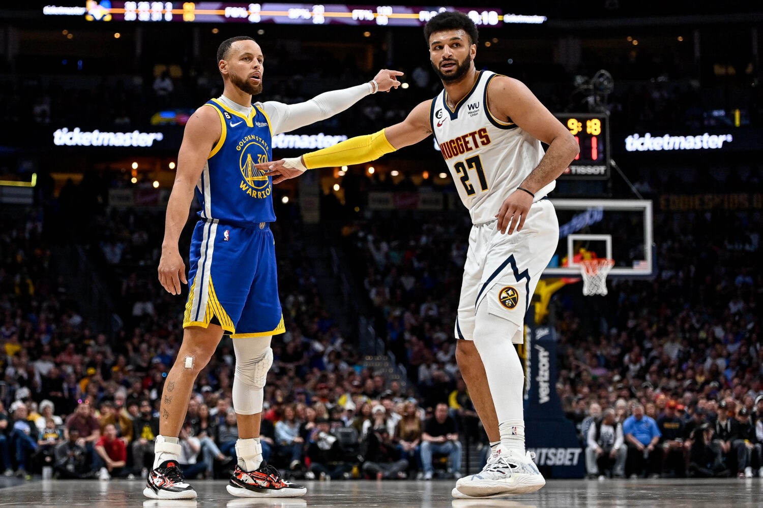 DENVER, CO - APRIL 2: Stephen Curry #30 of the Golden State Warriors is defended by Jamal Murray #2...