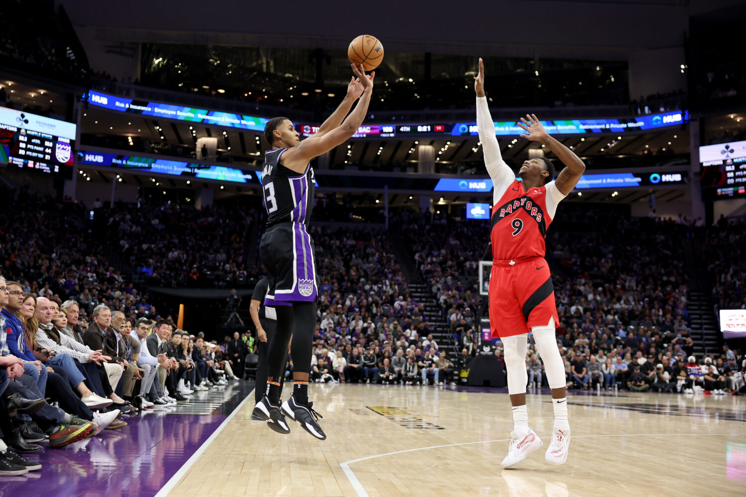 SACRAMENTO, CALIFORNIA - NOVEMBER 06: Keegan Murray #13 of the Sacramento Kings shoots over RJ Barr...
