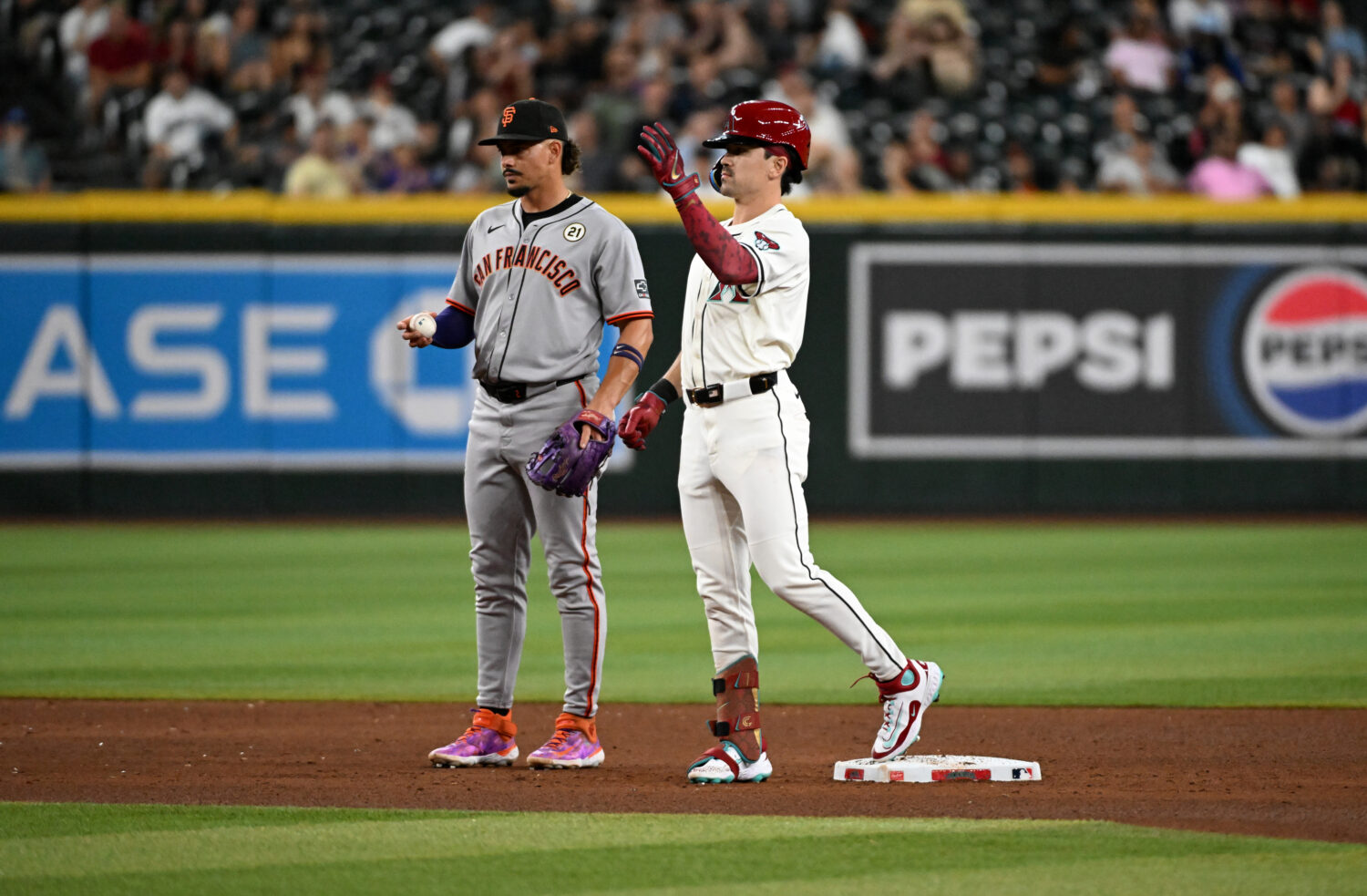 PHOENIX, ARIZONA - SEPTEMBER 15: Corbin Carroll #7 of the Arizona Diamondbacks gestures to the dugo...