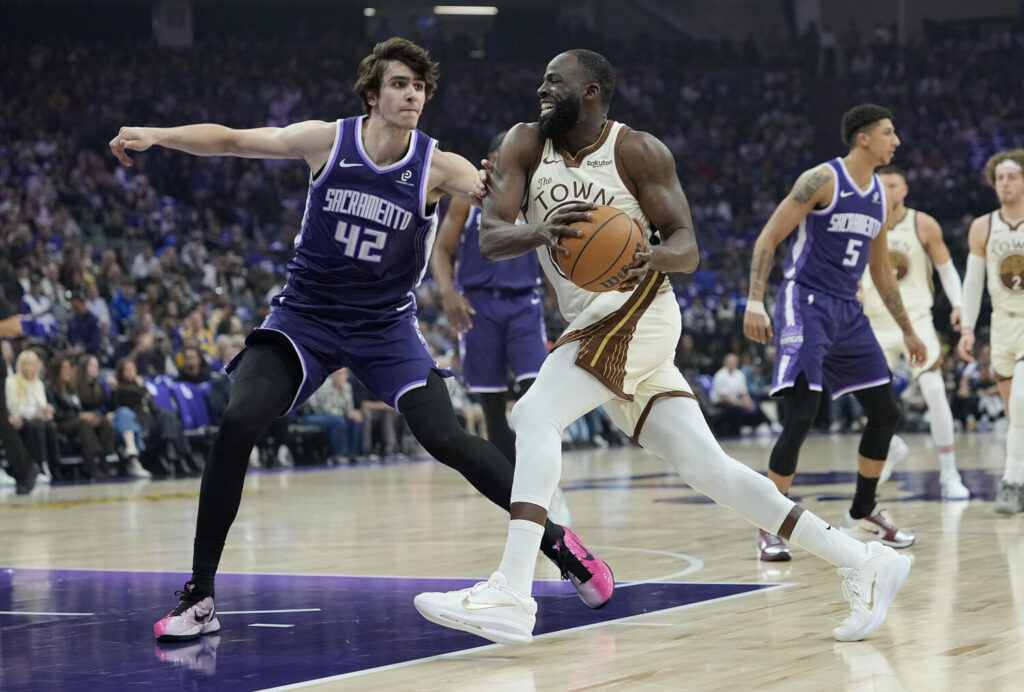 SACRAMENTO, CALIFORNIA - APRIL 10: Draymond Green #23 of the Golden State Warriors drives to the basket on Maxime Raynaud #42 of the Sacramento Kings in the first half at Golden 1 Center on April 10, 2026 in Sacramento, California. NOTE TO USER: User expressly acknowledges and agrees that, by downloading and or using this photograph, User is consenting to the terms and conditions of the Getty Images License Agreement. (Photo by Thearon W. Henderson/Getty Images)