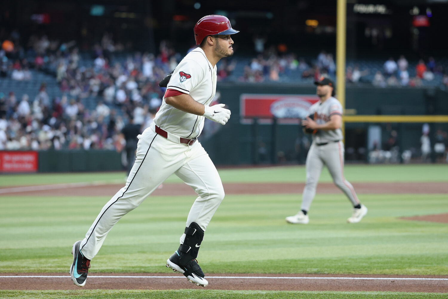 PHOENIX, ARIZONA - MAY 18: Nolan Arenado #28 of the Arizona Diamondbacks rounds the bases after hit...
