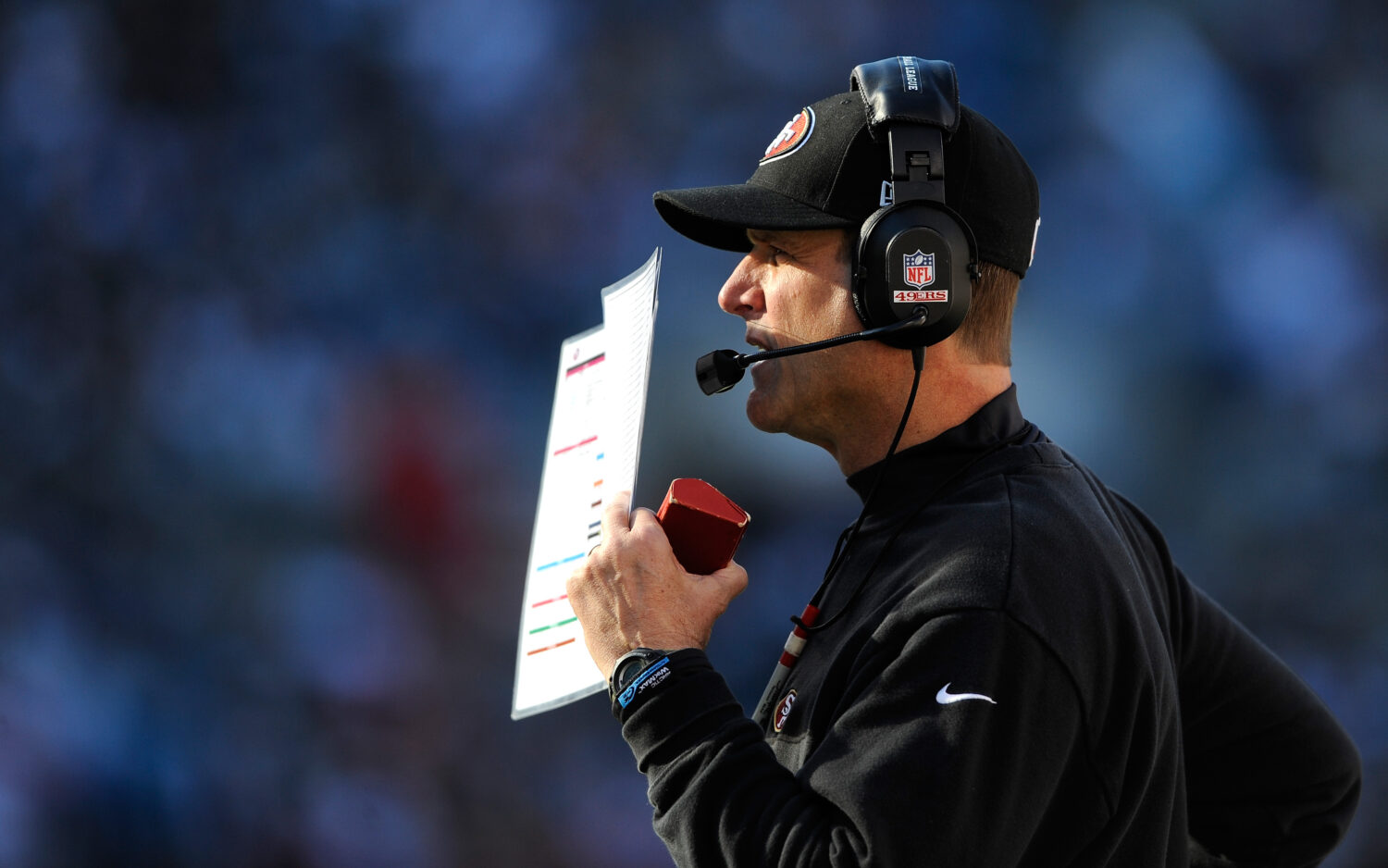 CHARLOTTE, NC - JANUARY 12: Head coach Jim Harbaugh of the San Francisco 49ers looks on from the si...
