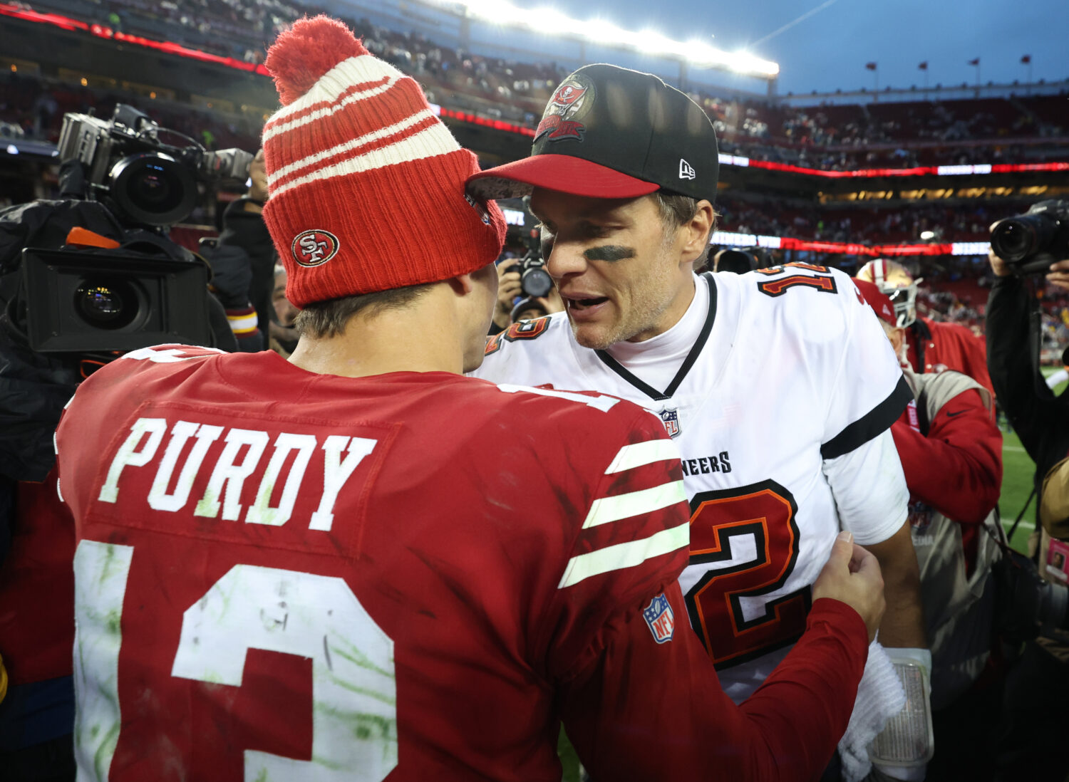 SANTA CLARA, CALIFORNIA - DECEMBER 11: Brock Purdy #13 of the San Francisco 49ers talks with Tom Br...