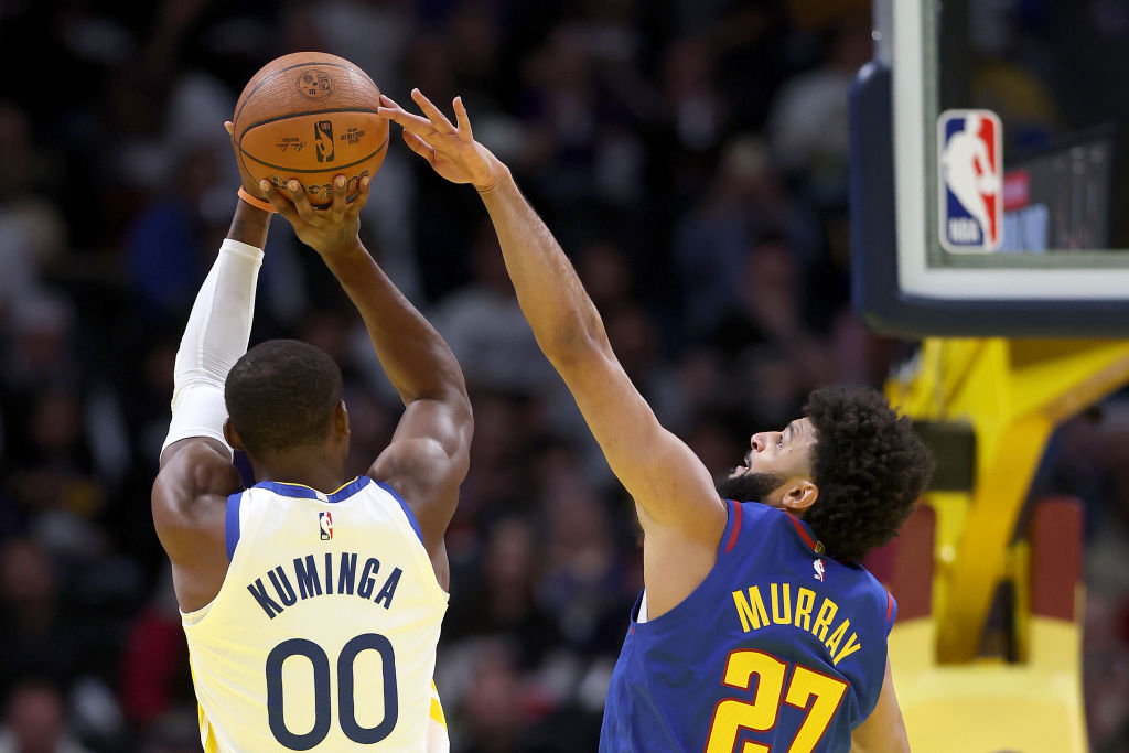 DENVER, COLORADO - DECEMBER 03: Jonathan Kuminga #00 of the Golden State Warriors puts up a shot ag...