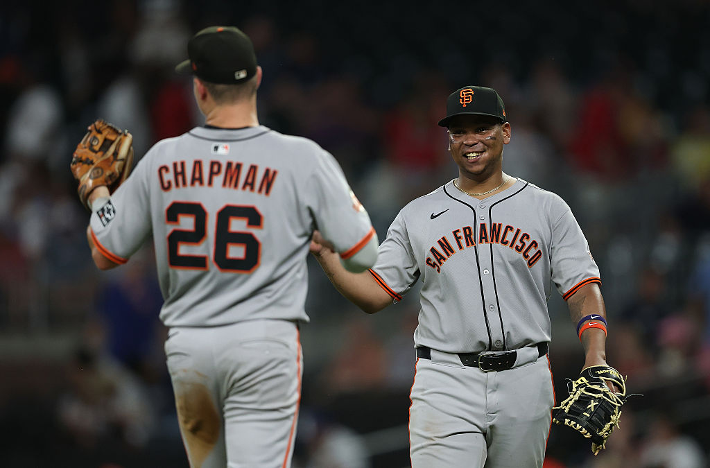 ATLANTA, GEORGIA - JULY 22: Matt Chapman #26 and Rafael Devers #16 of the San Francisco Giants reac...