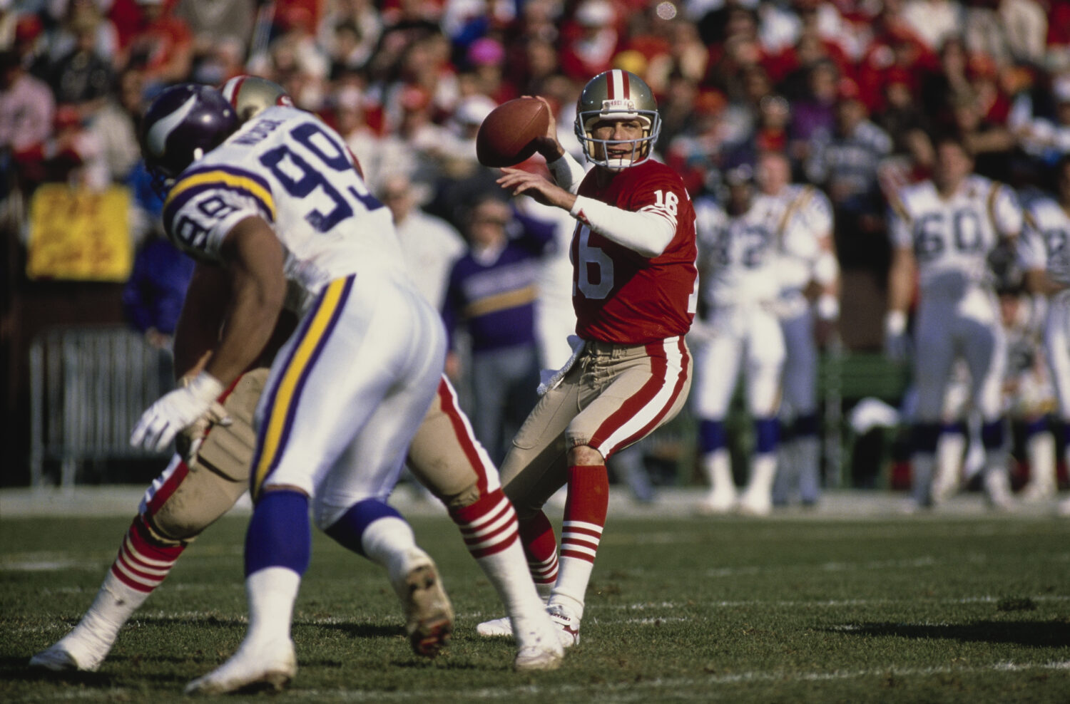 Joe Montana #16, Quarterback for the San Francisco 49ers prepares to throw a pass downfield during ...