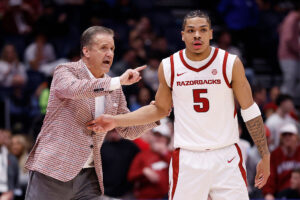 NASHVILLE, TENNESSEE - MARCH 13: Head coach John Calipari and Darius Acuff Jr. #5 of the Arkansas Razorbacks talk during the first half against the Oklahoma Sooners in the quarterfinal game of the 2026 SEC Men's Basketball Tournament at Bridgestone Arena on March 13, 2026 in Nashville, Tennessee. (Photo by Johnnie Izquierdo/Getty Images)