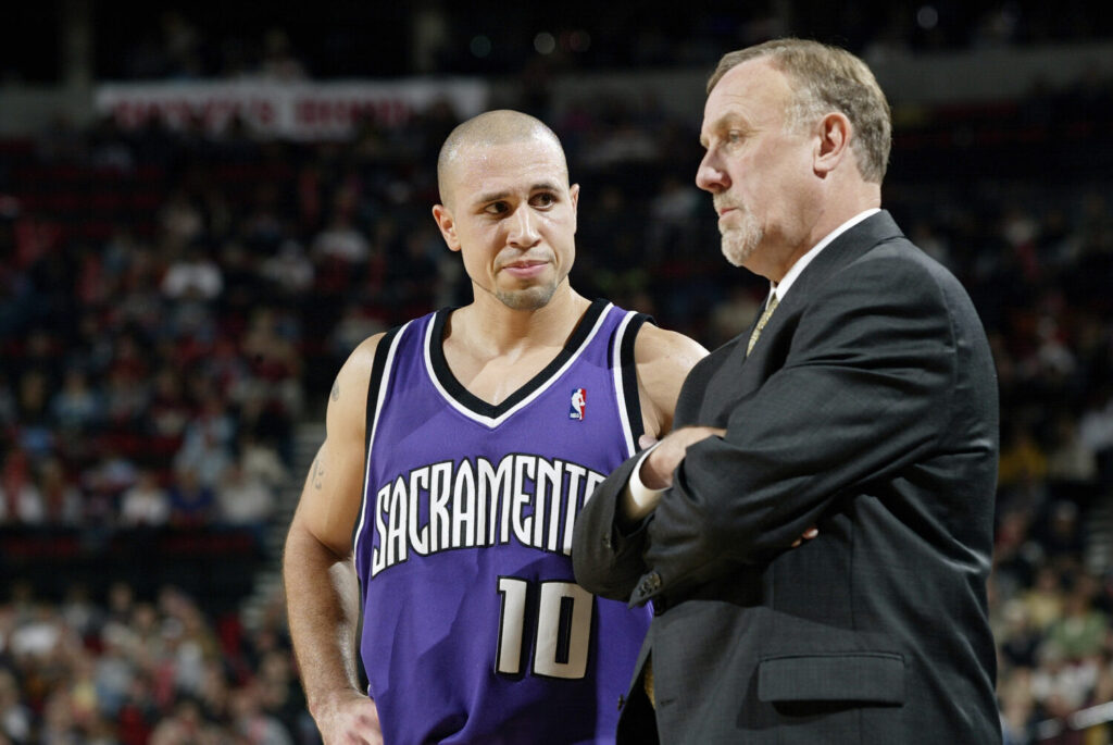 PORTLAND - NOVEMBER 13: Head coach Rick Adelman of the Sacramento Kings talks to his point guard Mike Bibby #10 during a break in the game against the Portland Trail Blazers at the Rose Garden on November 13, 2003 in Portland, Oregon. The Blazers won in overtime 112-110. NOTE TO USER: User expressly acknowledges and agrees that, by downloading and/or using this Photograph, User is consenting to the terms and conditions of the Getty Images License Agreement (Photo by Jonathan Ferrey/Getty Images)