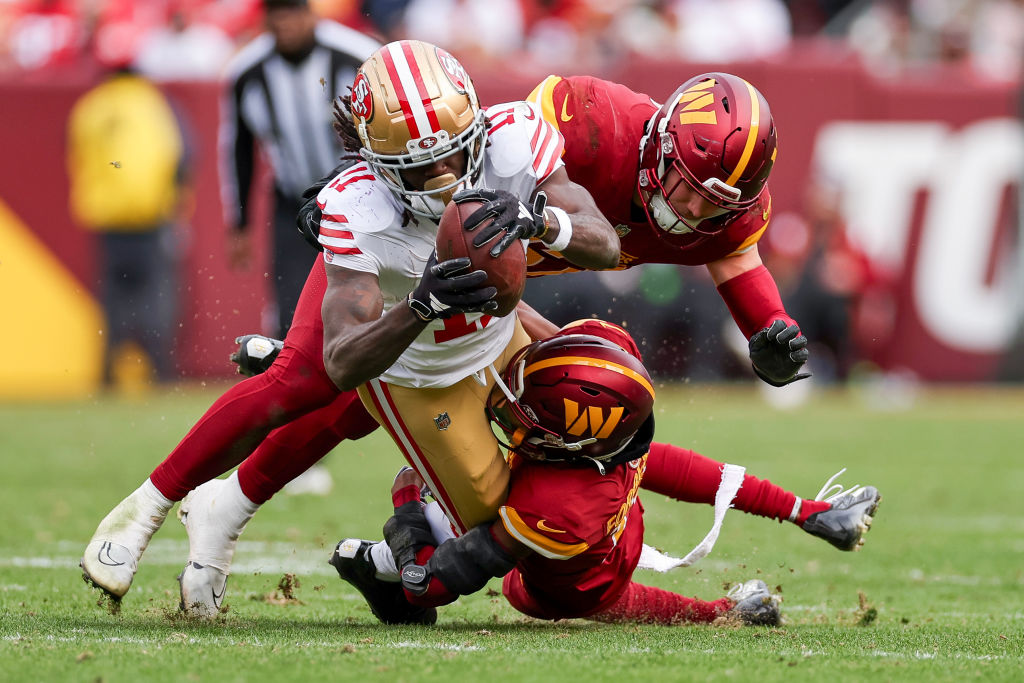 LANDOVER, MARYLAND - DECEMBER 31: Cody Barton #57 of the Washington Commanders tackles Brandon Aiyu...
