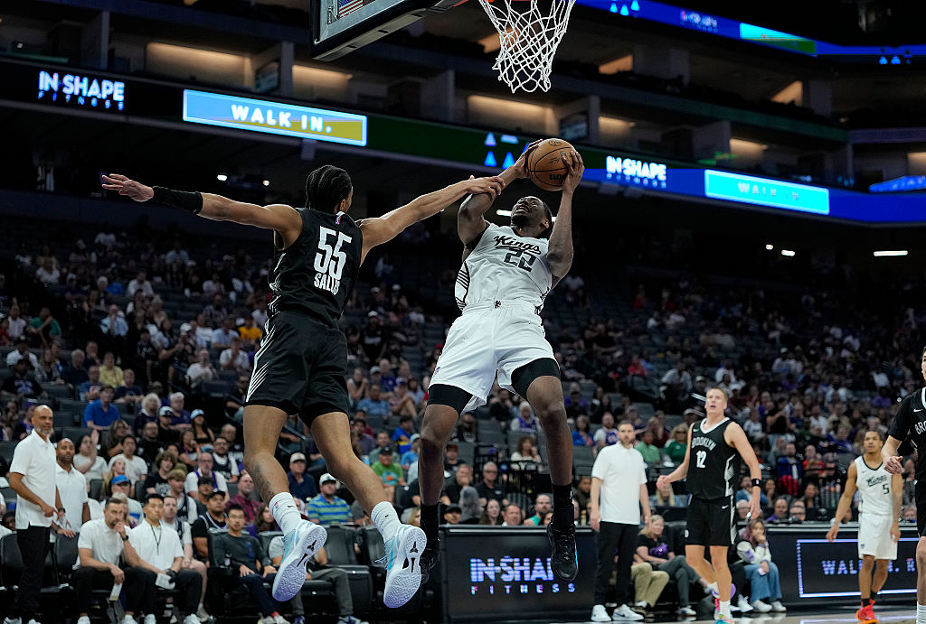 SACRAMENTO, CALIFORNIA - JULY 04: Jonathan Mogbo #22 of the Sacramento kings gets fouled on his shot by Hunter Sallis #55 of the Brooklyn Nets during the second half in the California Classic a NBA Summer League game at Golden 1 Center on July 04, 2026 in Sacramento, California. NOTE TO USER: User expressly acknowledges and agrees that, by downloading and or using this photograph, User is consenting to the terms and conditions of the Getty Images License Agreement. (Photo by Thearon W. Henderson/Getty Images)