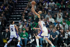 SACRAMENTO, CALIFORNIA - JANUARY 01: Derrick White #9 of the Boston Celtics shoots over Nique Clifford #5 and Drew Eubanks #19 of the Sacramento Kings in the first half of an NBA basketball game at Golden 1 Center on January 01, 2026 in Sacramento, California. NOTE TO USER: User expressly acknowledges and agrees that, by downloading and or using this photograph, User is consenting to the terms and conditions of the Getty Images License Agreement. (Photo by Thearon W. Henderson/Getty Images)