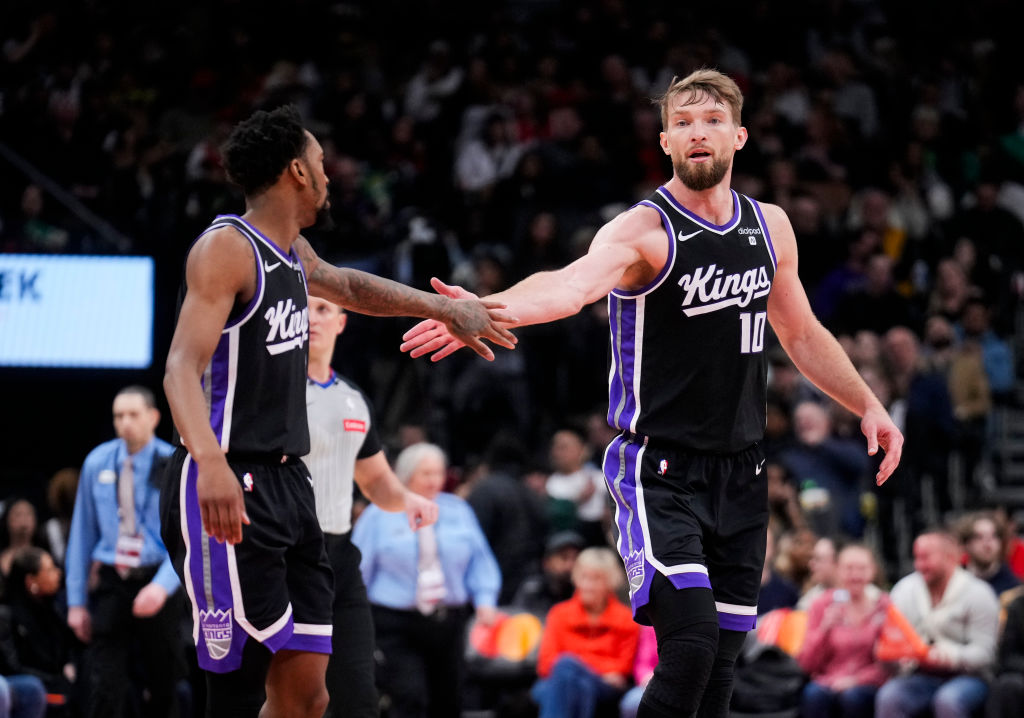 TORONTO, ON - MARCH 20: Domantas Sabonis #10 and Malik Monk #0 of the Sacramento Kings celebrate against the Toronto Raptors during the second half at the Scotiabank Arena on March 20, 2024 in Toronto, Ontario, Canada. NOTE TO USER: User expressly acknowledges and agrees that, by downloading and/or using this Photograph, user is consenting to the terms and conditions of the Getty Images License Agreement. (Photo by Mark Blinch/Getty Images)
