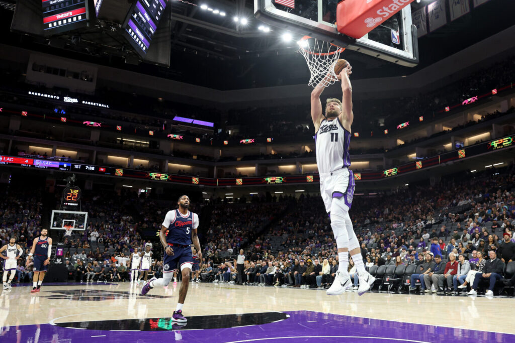 SACRAMENTO, CALIFORNIA - OCTOBER 15: Domantas Sabonis #11 of the Sacramento Kings goes up for a dunk on Derrick Jones Jr. #5 of the LA Clippers during their preseason game at Golden 1 Center on October 15, 2025 in Sacramento, California. NOTE TO USER: User expressly acknowledges and agrees that, by downloading and/or using this photograph, user is consenting to the terms and conditions of the Getty Images License Agreement. (Photo by Ezra Shaw/Getty Images)