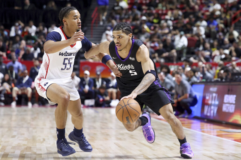 LAS VEGAS, NEVADA - JULY 12: Darius Acuff Jr. #5 of the Sacramento Kings drives against Seth Trimble #55 of the Washington Wizards in the third quarter of a 2026 NBA Summer League game at the Thomas & Mack Center on July 12, 2026 in Las Vegas, Nevada. (Photo by Ian Maule/Getty Images)