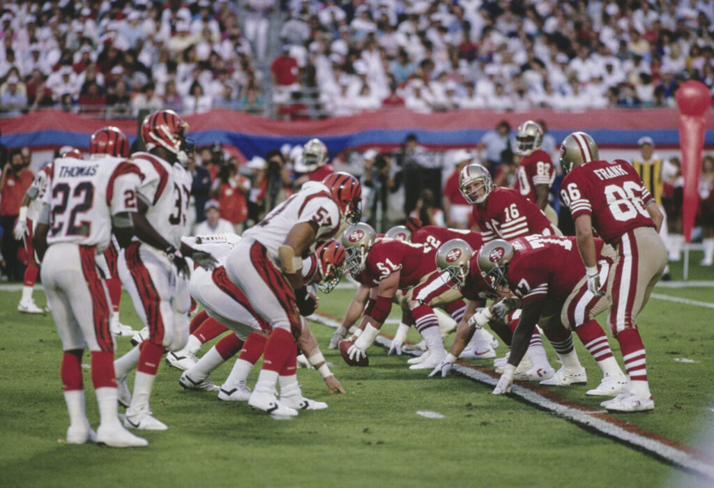 Joe Montana #16, Quarterback for the San Francisco 49ers calls the play on the line of scrimmage during the National Football League Super Bowl XXIII game against the Cincinnati Bengals on 22nd January 1989 at the Joe Robbie Stadium, Miami, Florida, United States. The 49ers won the game 20 - 16. (Photo by Rick Stewart/Allsport/Getty Images)