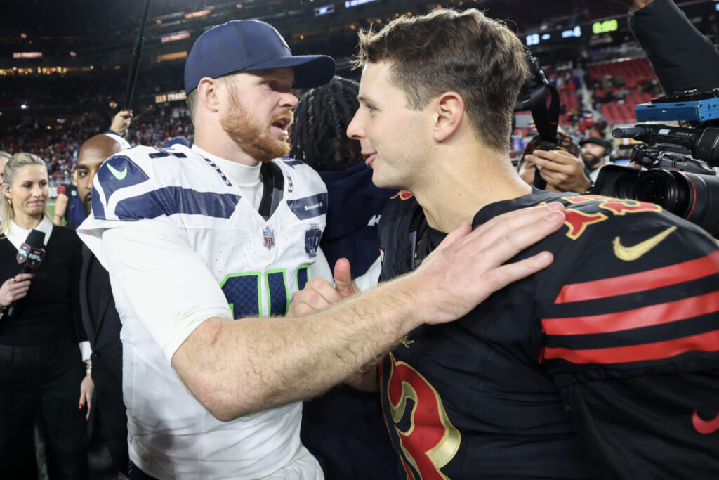 SANTA CLARA, CALIFORNIA - JANUARY 03: Brock Purdy #13 of the San Francisco 49ers shakes hand with Sam Darnold #14 of the Seattle Seahawks following a game at Levi's Stadium on January 03, 2026 in Santa Clara, California. The Seattle Seahawks defeated the San Francisco 49ers 13-3. (Photo by Ezra Shaw/Getty Images)