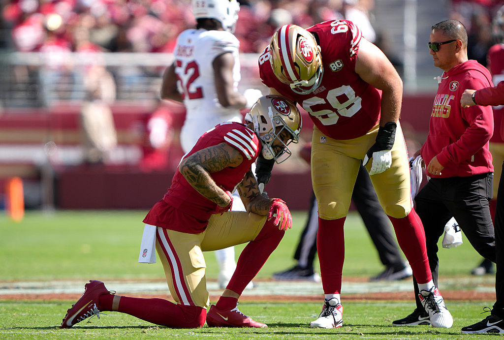 SANTA CLARA, CALIFORNIA - SEPTEMBER 27: Mike Evans #5 of the San Francisco 49ers kneels in pain as ...