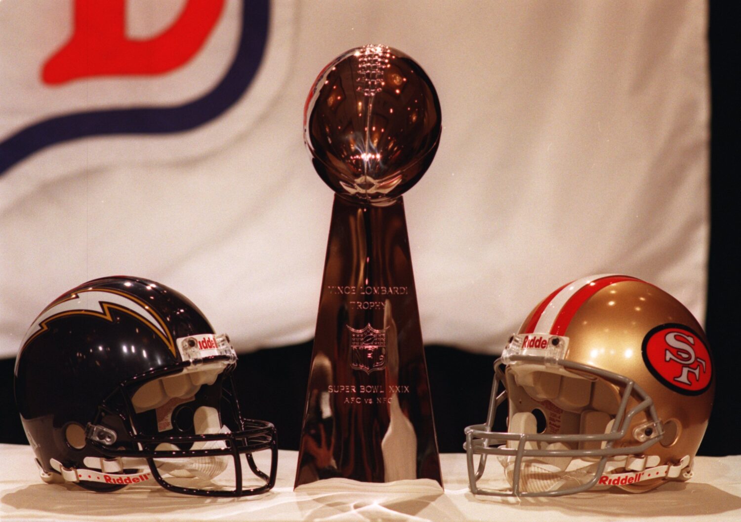 27 JAN 1995: THE LOMBARDI TROPHY IS DISPLAYED WITH THE HELMETS REPRESENTING THE TWO TEAMS PARTICIPA...