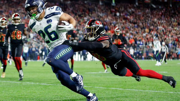 SANTA CLARA, CALIFORNIA - JANUARY 03: Zach Charbonnet #26 of the Seattle Seahawks scores a touchdown against Malik Mustapha #6 of the San Francisco 49ers during the first quarter of a game at Levi's Stadium on January 03, 2026 in Santa Clara, California. (Photo by Lachlan Cunningham/Getty Images)
