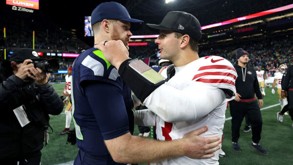 SEATTLE, WASHINGTON - JANUARY 17: Brock Purdy #13 of the San Francisco 49ers and Sam Darnold #14 of the Seattle Seahawks embrace after the game in the NFC Divisional Playoff game at Lumen Field on January 17, 2026 in Seattle, Washington. (Photo by Harry How/Getty Images)