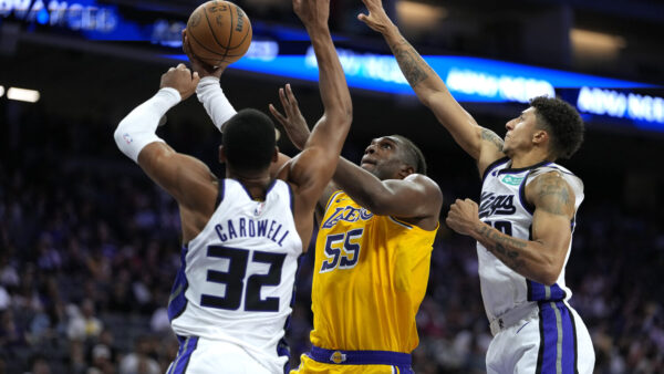 SACRAMENTO, CALIFORNIA - OCTOBER 05: Kevon Looney #55 of the Los Angeles Lakers drives to the basket against Dylan Cardwell #32 and Nique Clifford #10 of the Sacramento Kings in the second half of a preseason game at Golden 1 Center on October 05, 2026 in Sacramento, California. NOTE TO USER: User expressly acknowledges and agrees that, by downloading and or using this photograph, User is consenting to the terms and conditions of the Getty Images License Agreement. (Photo by Thearon W. Henderson/Getty Images)