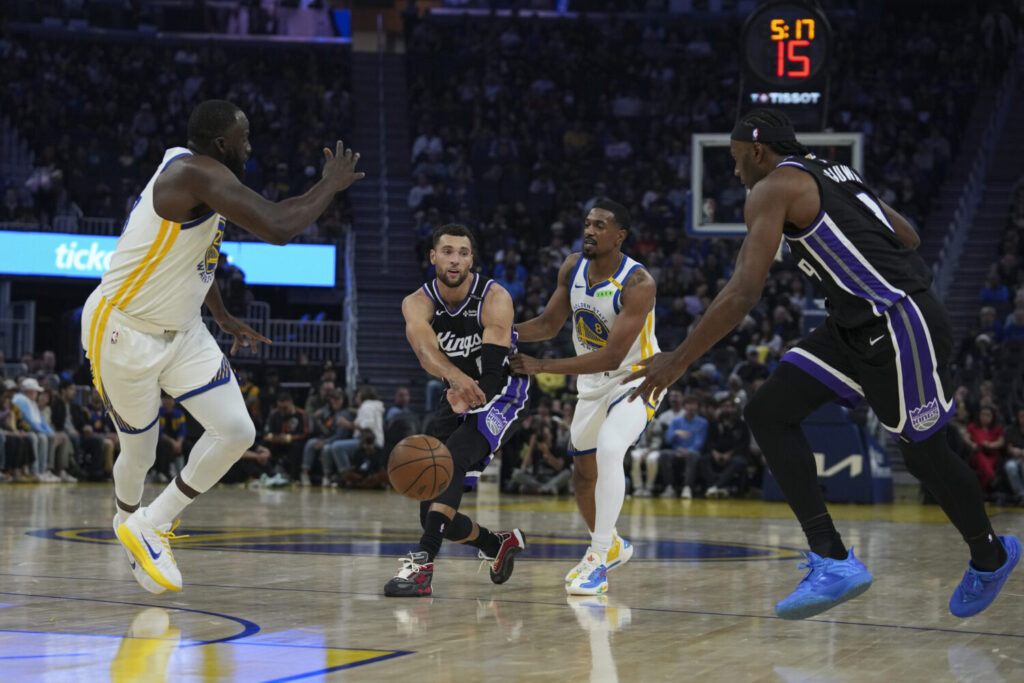SAN FRANCISCO, CALIFORNIA - OCTOBER 10: Zach LaVine #8 of the Sacramento Kings passes the ball to Precious Achiuwa #9 while defended by De'Anthony Melton #8 of the Golden State Warriors during the first half of the preseason game at Chase Center on October 10, 2026 in San Francisco, California. NOTE TO USER: User expressly acknowledges and agrees that, by downloading and or using this photograph, User is consenting to the terms and conditions of the Getty Images License Agreement. (Photo by Godofredo A. Vásquez/Getty Images)