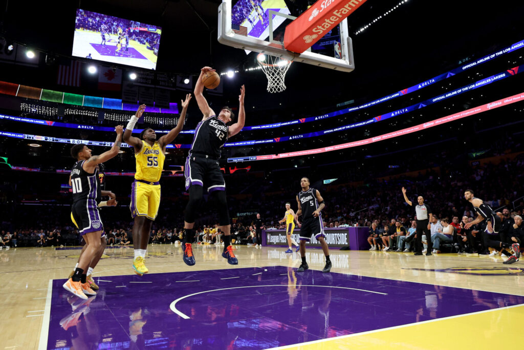 LOS ANGELES, CALIFORNIA - OCTOBER 08: Maxime Raynaud #42 of the Sacramento Kings rebounds against Kevon Looney #55 of the Los Angeles Lakers during the second quarter in a preseason game at Crypto.com Arena on October 08, 2026 in Los Angeles, California. NOTE TO USER: User expressly acknowledges and agrees that, by downloading and or using this photograph, user is consenting to the terms and conditions of the Getty Images License Agreement. (Photo by Luke Hales/Getty Images)